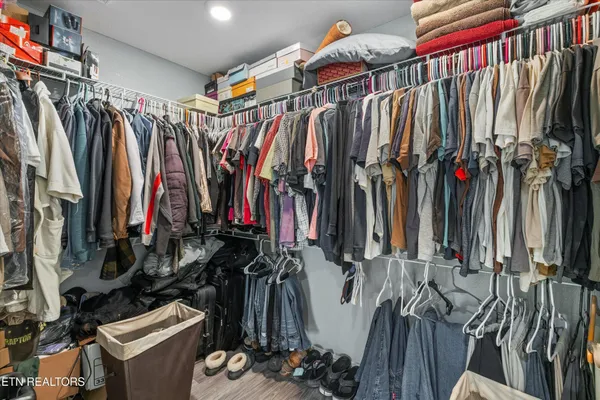 a view of walk in closet with clothes