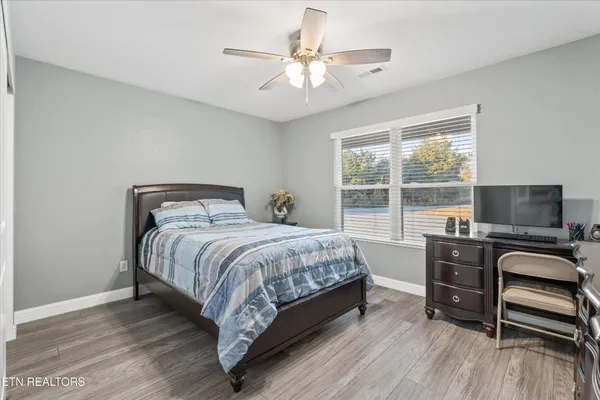 a bedroom with a bed and a desk