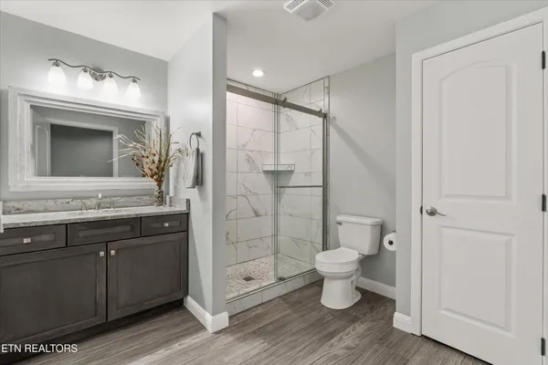 a bathroom with a toilet sink and a mirror
