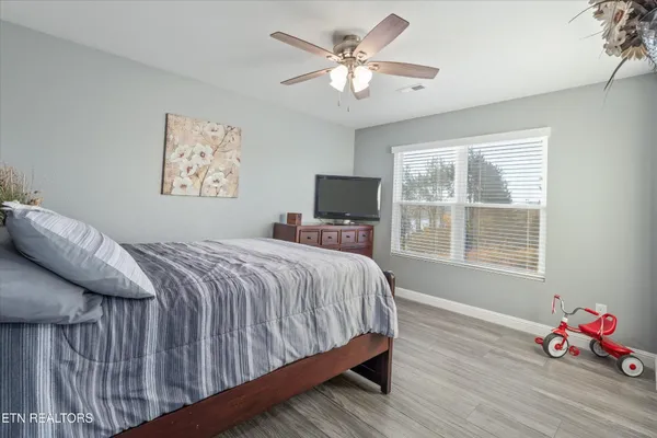 a bedroom with a bed and a window