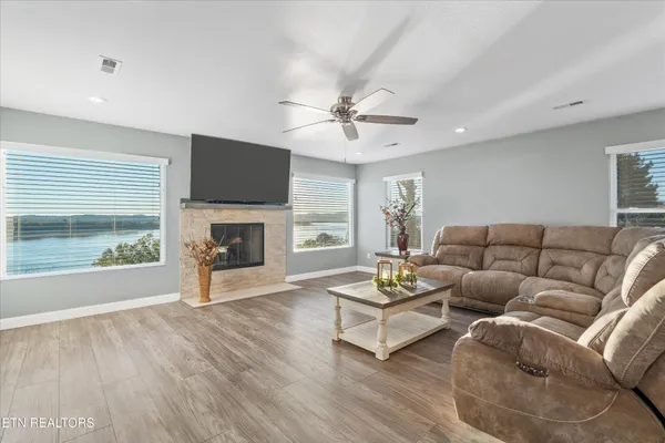 a living room with furniture a fireplace and a flat screen tv