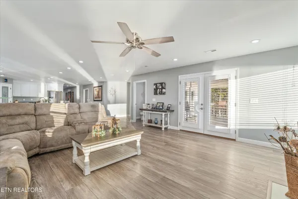 a living room with furniture and wooden floor