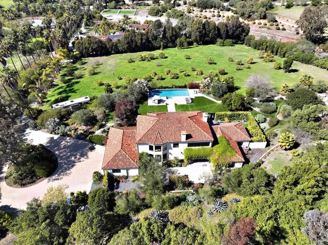 an aerial view of residential houses and outdoor space