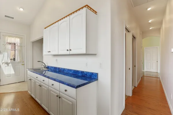 a kitchen with white cabinets and white appliances