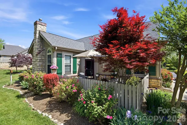 a view of a house with a flower garden