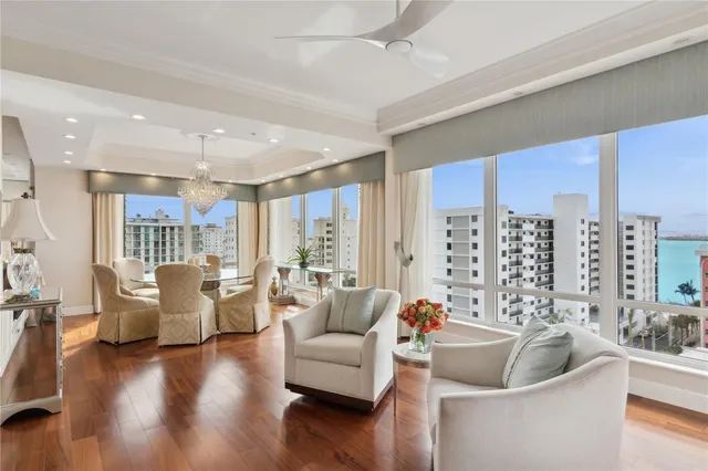 a living room with furniture or chandelier and a large window