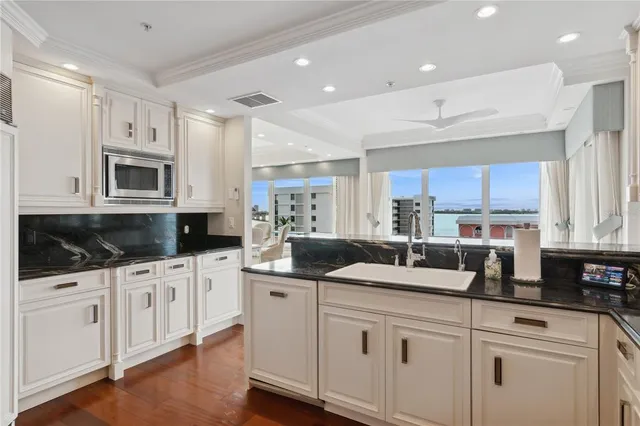 a kitchen with granite countertop a sink and cabinets