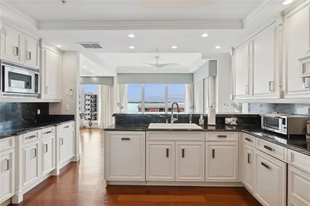 a kitchen with stainless steel appliances a stove refrigerator and cabinets