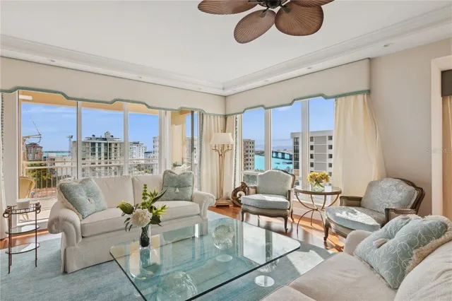 a living room with furniture ceiling fan and a flat screen tv