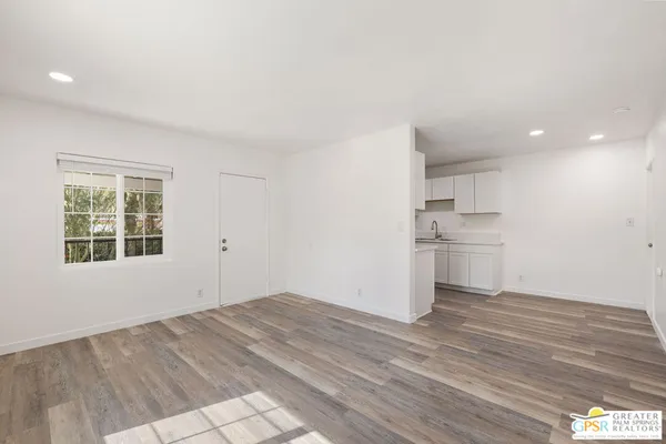 a view of a kitchen with wooden floor and a sink
