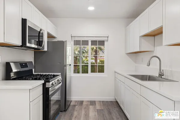 a kitchen with stainless steel appliances granite countertop a stove and a sink