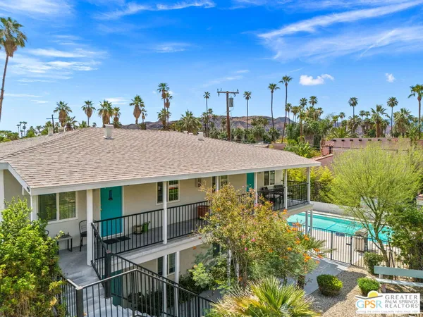 a aerial view of a house with swimming pool garden and patio