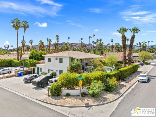an aerial view of a house with a yard and potted plants