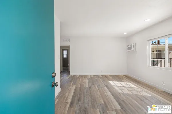 a view of a room with wooden floor and windows