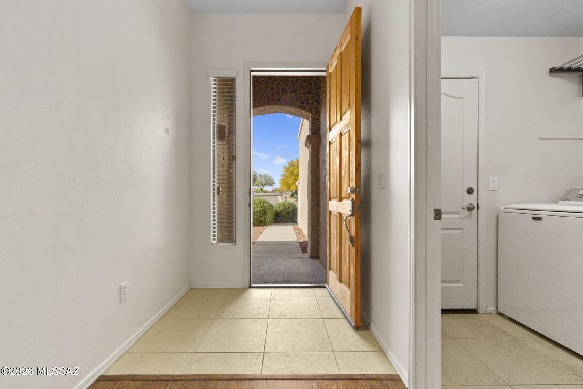 13668 East High Plains Ranch Street Vail, AZ 85641 - Photo 8 of 51 a view of a hallway with a glass door and furniture