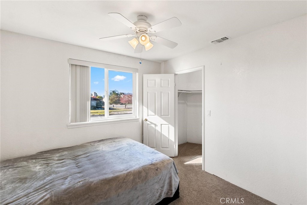 1076 Occidental Circle Redlands, CA 92374 - Photo 15 of 28 a bedroom with a bed and a window