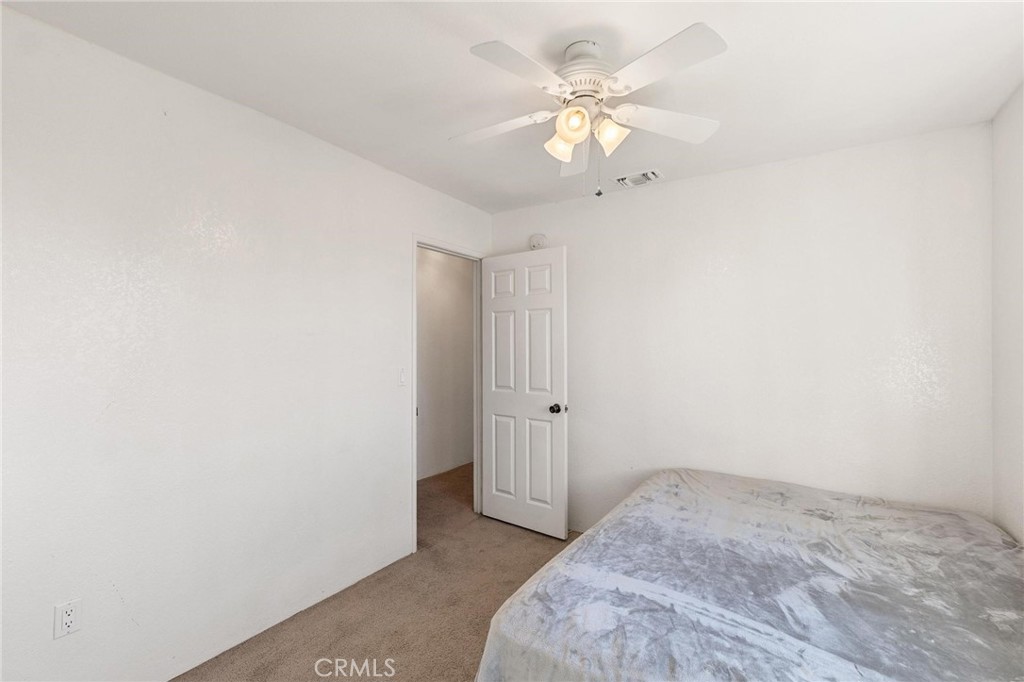 1076 Occidental Circle Redlands, CA 92374 - Photo 16 of 28 a view of a bedroom with a chandelier fan