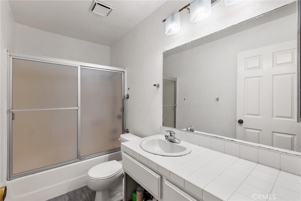 1076 Occidental Circle Redlands, CA 92374 - Photo 17 of 28 a bathroom with a sink toilet and shower