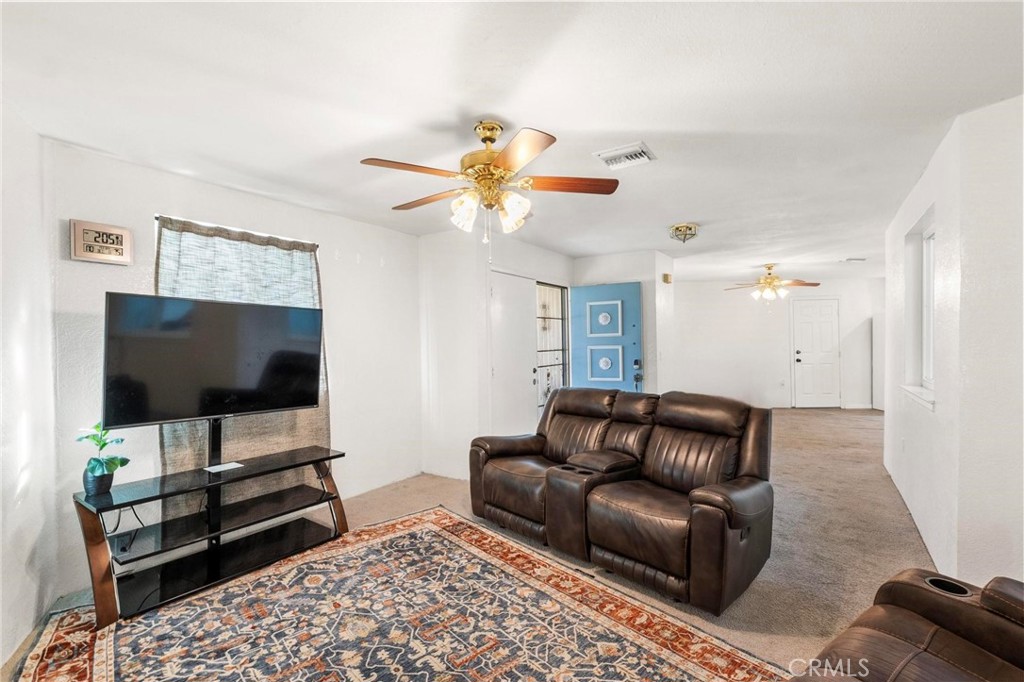 1076 Occidental Circle Redlands, CA 92374 - Photo 5 of 28 a living room with furniture and a flat screen tv