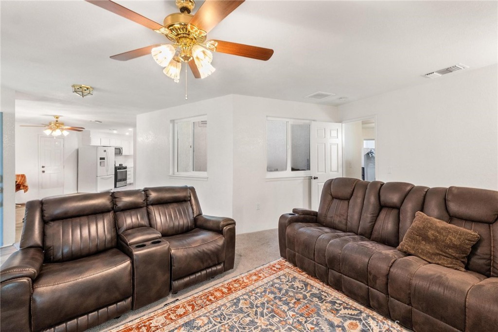 1076 Occidental Circle Redlands, CA 92374 - Photo 7 of 28 a living room with furniture and a chandelier