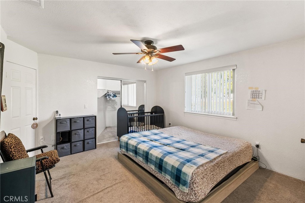 1076 Occidental Circle Redlands, CA 92374 - Photo 9 of 28 a bedroom with a bed and furniture