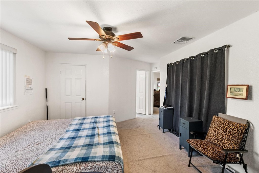 1076 Occidental Circle Redlands, CA 92374 - Photo 10 of 28 a bedroom with a bed and a chair