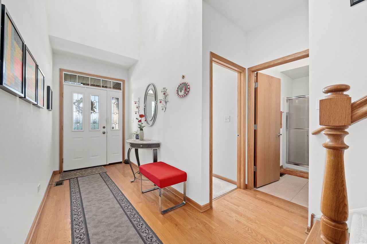 1343 Camelot Lane Lemont, IL 60439 - Photo 11 of 37 a living room with furniture a rug and a table