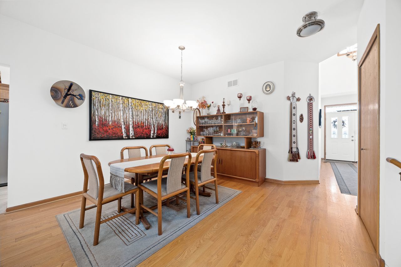 1343 Camelot Lane Lemont, IL 60439 - Photo 13 of 37 a view of a dining room with furniture and wooden floor