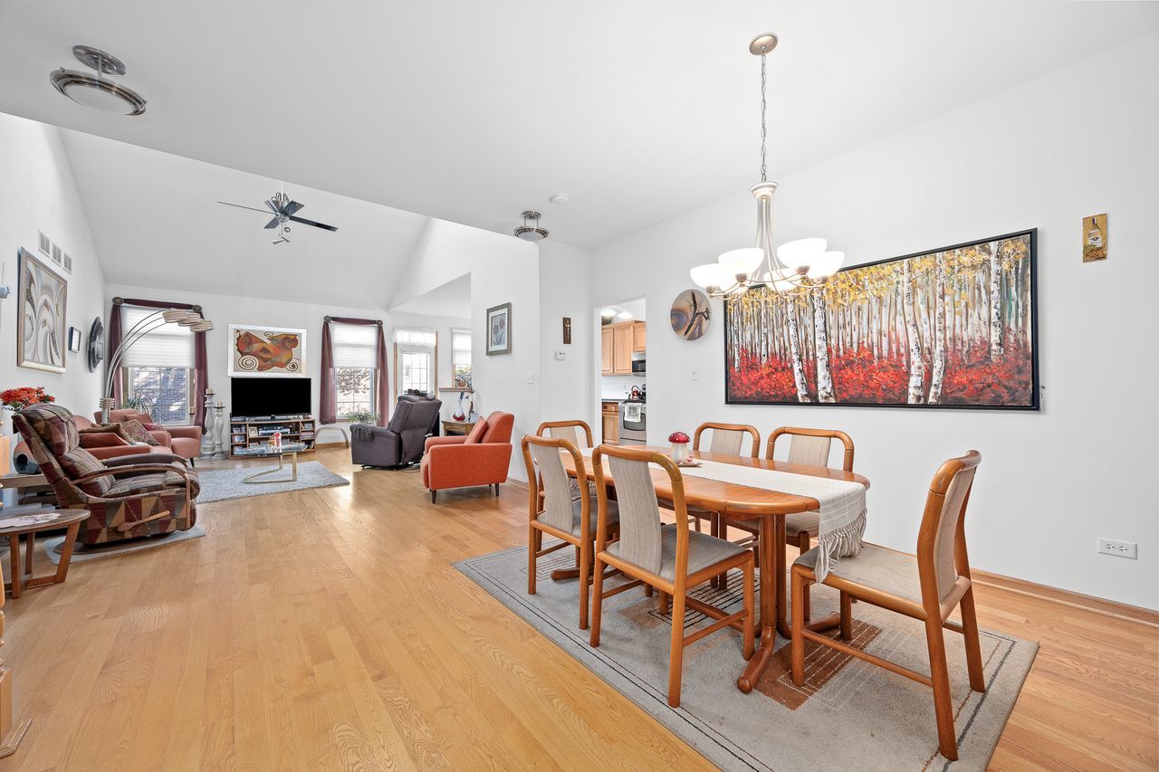 1343 Camelot Lane Lemont, IL 60439 - Photo 14 of 37 a view of a dining room with furniture window and wooden floor