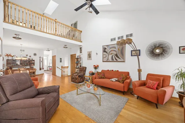 a living room with furniture and a chandelier
