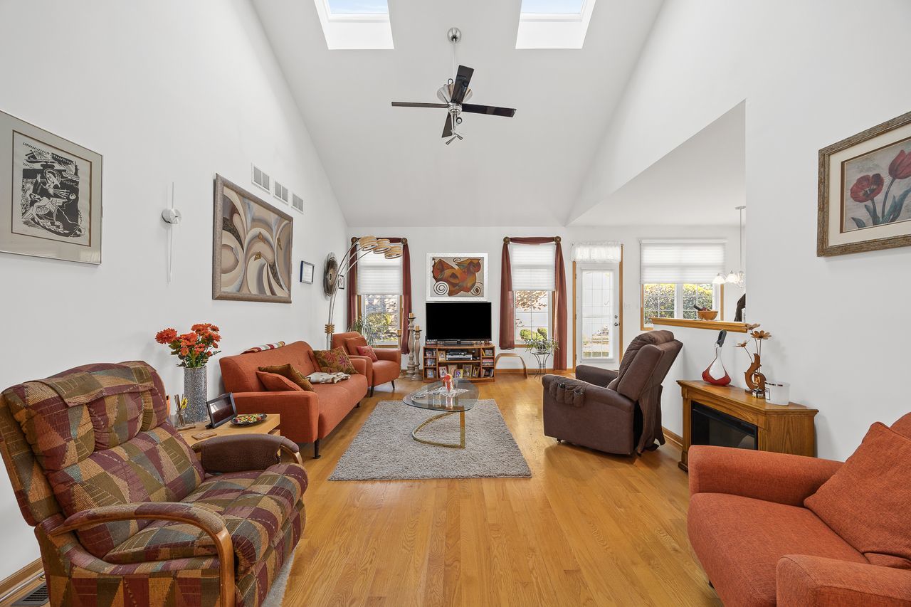 1343 Camelot Lane Lemont, IL 60439 - Photo 16 of 37 a living room with furniture or couch and a fireplace