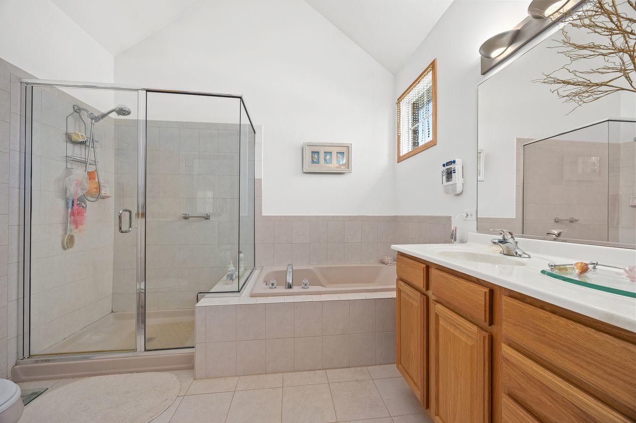 1343 Camelot Lane Lemont, IL 60439 - Photo 25 of 37 a bathroom with a tub sink shower and mirror