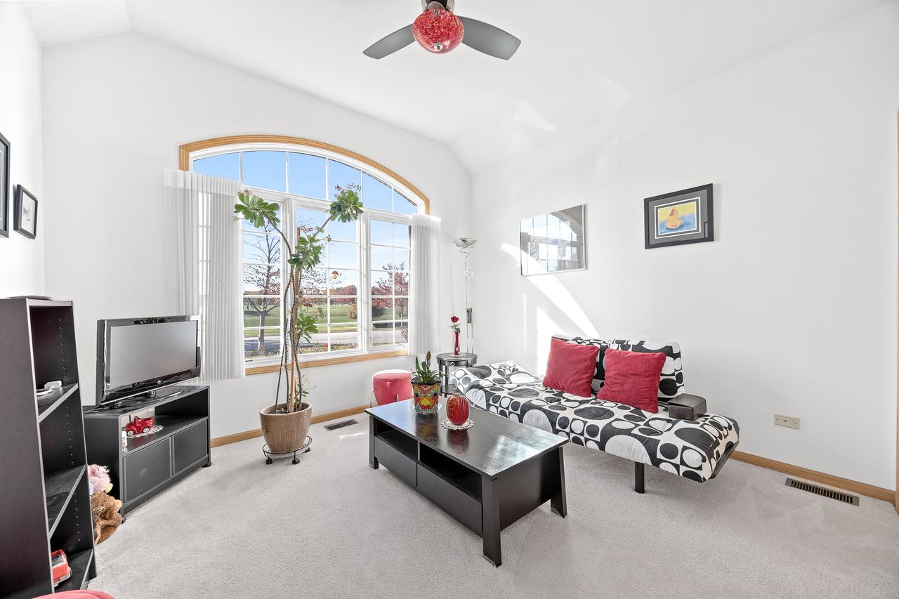 1343 Camelot Lane Lemont, IL 60439 - Photo 26 of 37 a living room with furniture and a flat screen tv