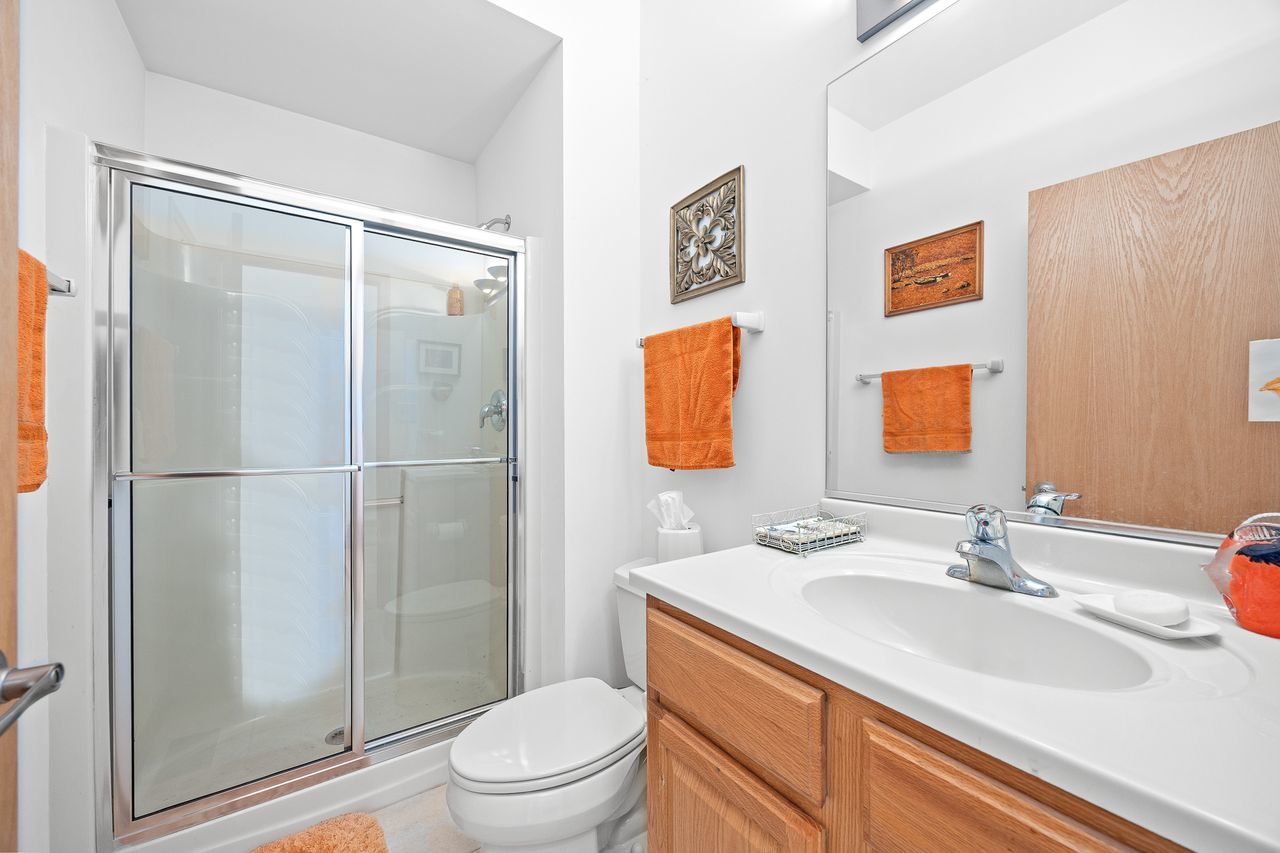 1343 Camelot Lane Lemont, IL 60439 - Photo 28 of 37 a bathroom with a granite countertop sink toilet and shower