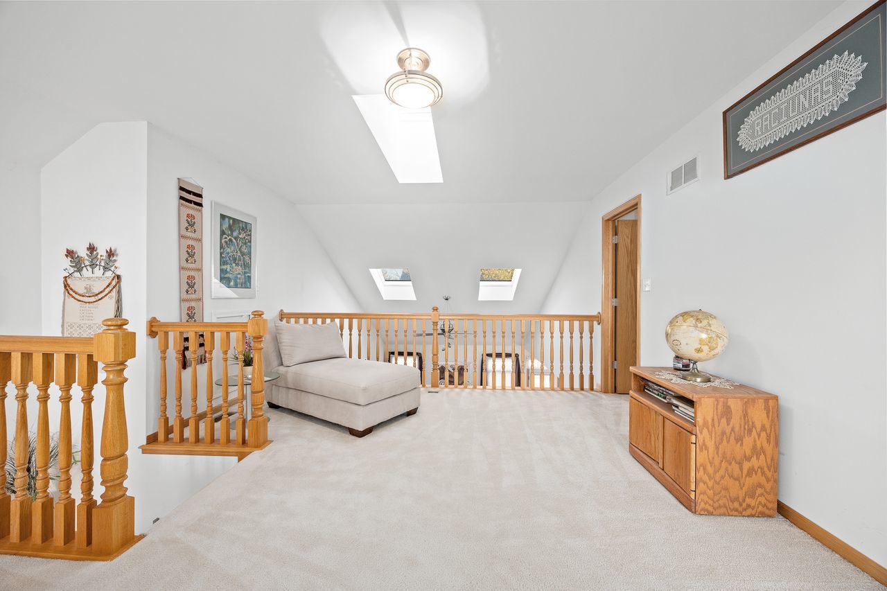 1343 Camelot Lane Lemont, IL 60439 - Photo 29 of 37 a bedroom with furniture and a chandelier