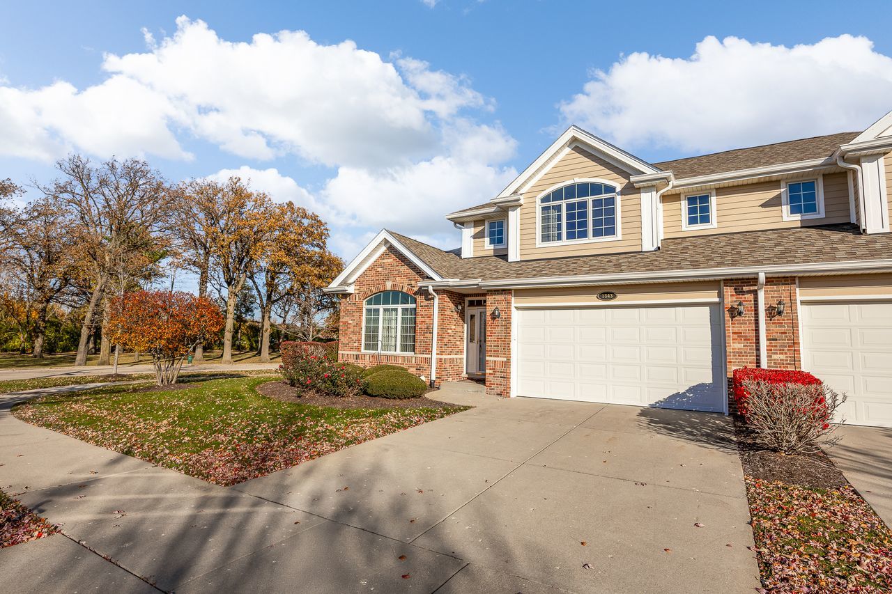 1343 Camelot Lane Lemont, IL 60439 - Photo 3 of 37 a front view of a house with a yard and garage