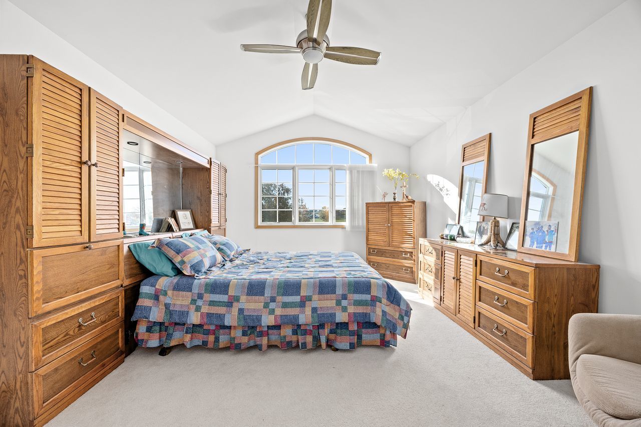 1343 Camelot Lane Lemont, IL 60439 - Photo 32 of 37 a bedroom with a bed and a large window