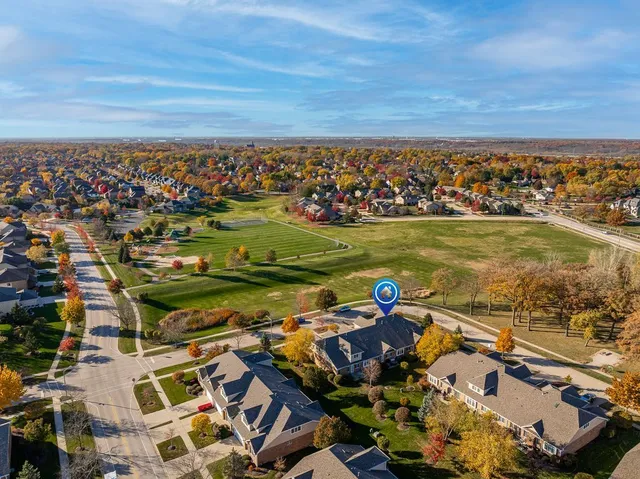 an aerial view of a city with lots of residential buildings ocean and mountain view in back