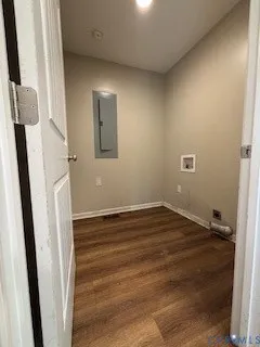 a view of a livingroom with wooden floor and staircase