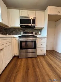 a kitchen with stainless steel appliances a stove a microwave and cabinets