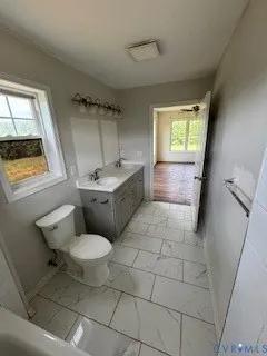 a bathroom with a sink toilet and mirror
