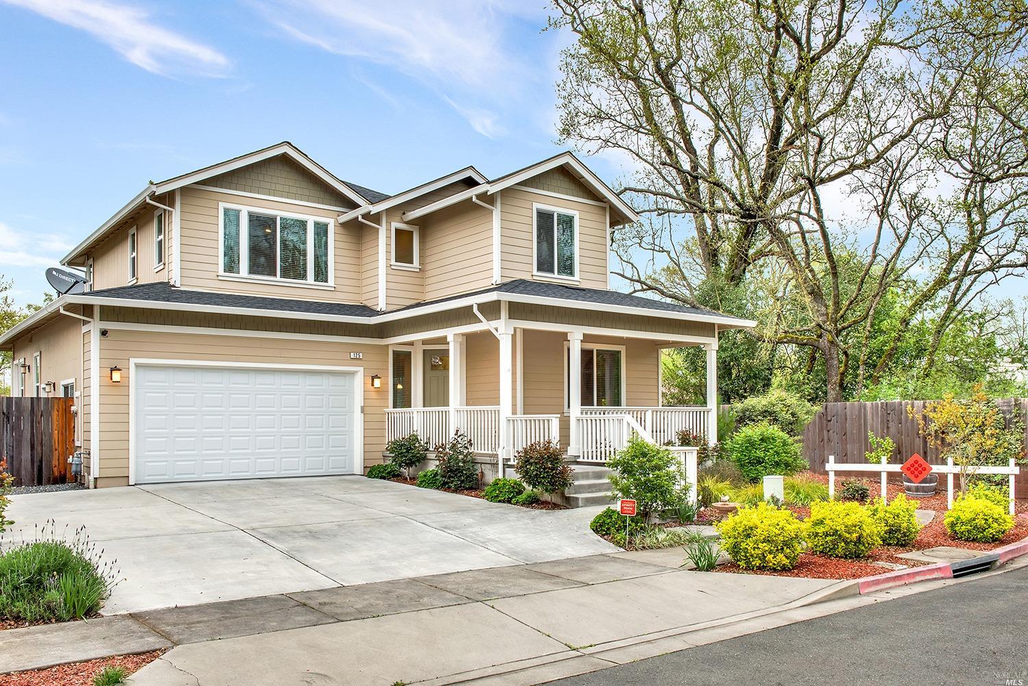 a front view of a house with a garden and plants