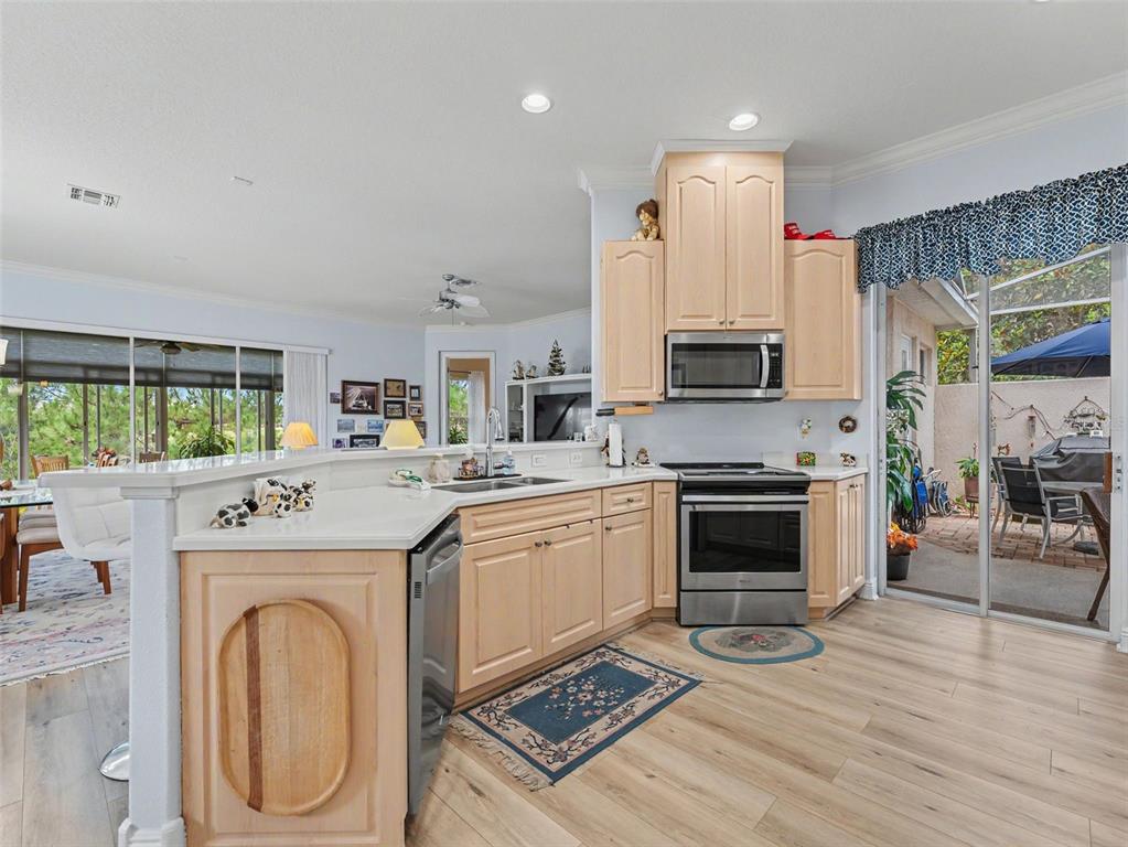 8910 Jericho Road Weeki Wachee, FL 34613 - Photo 24 of 52 a kitchen with a stove a sink and a refrigerator