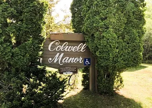 a view of outdoor space with sign board and tree