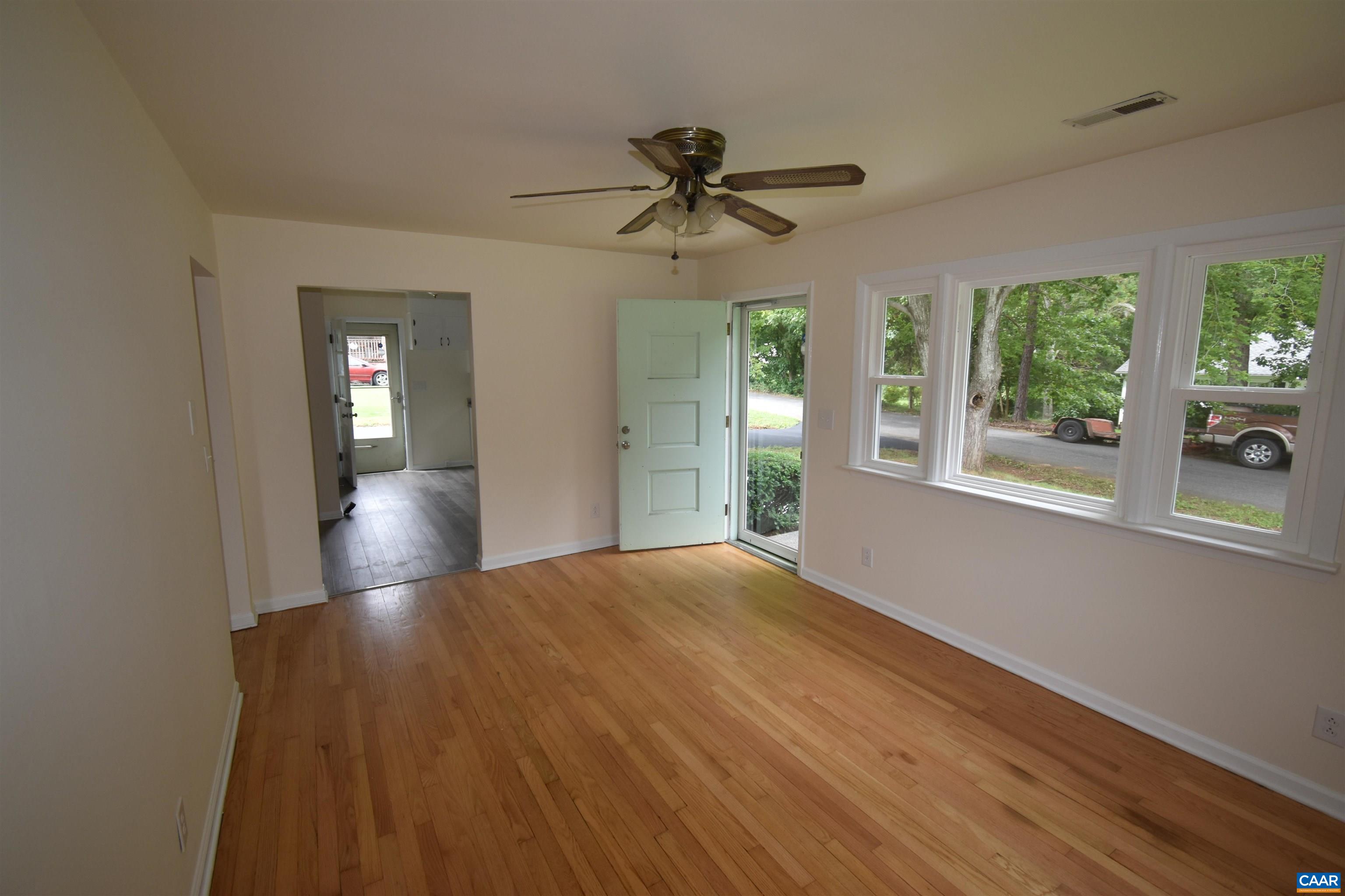 100 Locust Lane Ruckersville, VA 22968 - Photo 10 of 25 a view of a livingroom with wooden floor a ceiling fan and windows
