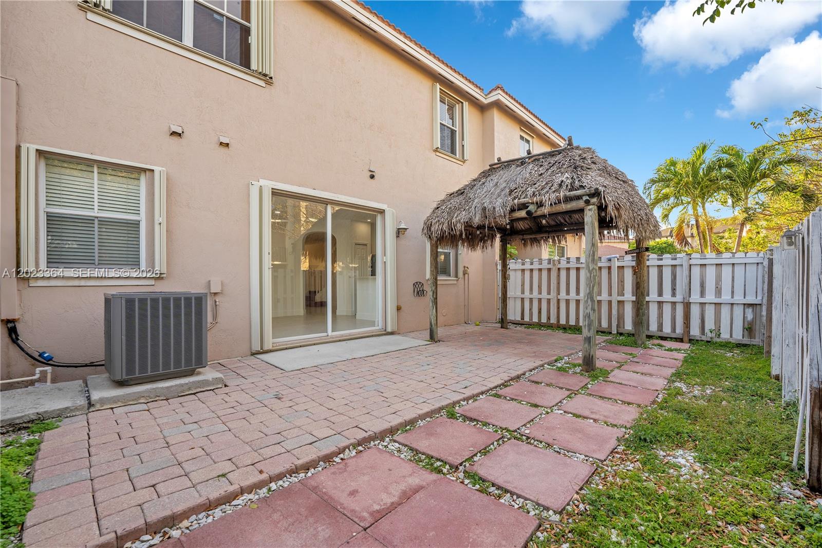27433 Southwest 137th Court, Unit 1 Homestead, FL 33032 - Photo 22 of 28 a front view of a house having yard