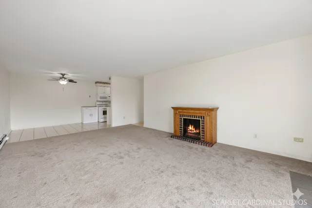a view of empty room with a fireplace