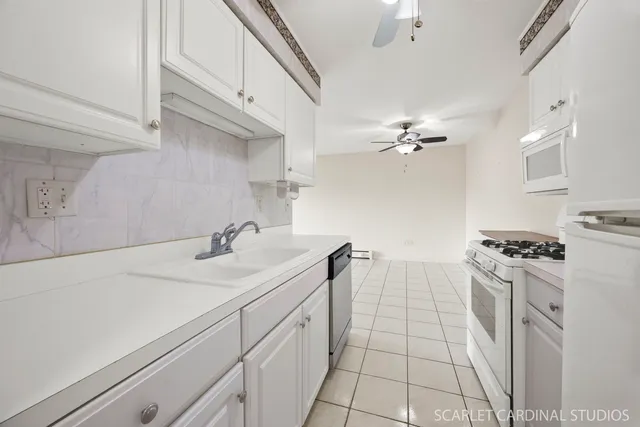 a kitchen with a sink appliances and cabinets