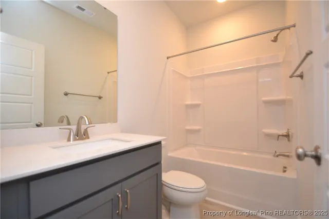 a bath tub sitting next to a white sink