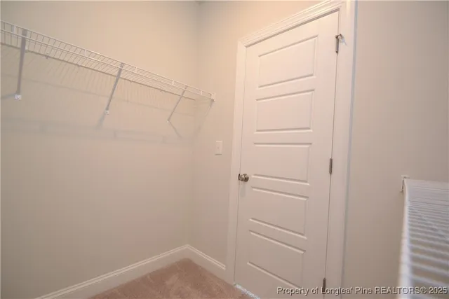 a view of an empty room with a kitchen